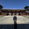 寺院で記念撮影する男性